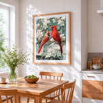 Pair of cardinals on blossom branch cross stitch artwork displayed on wall as home decor
