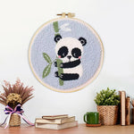 Finished panda and bamboo artwork displayed on a wall