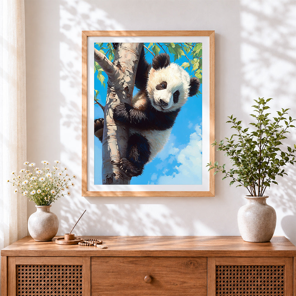 Finished panda cub climbing a tree cross stitch artwork displayed