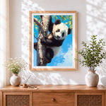Finished panda cub climbing a tree cross stitch artwork displayed
