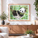 Finished panda cub in a hammock cross stitch artwork displayed