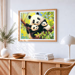 Panda family in a tree cross stitch artwork displayed on wall as home decor