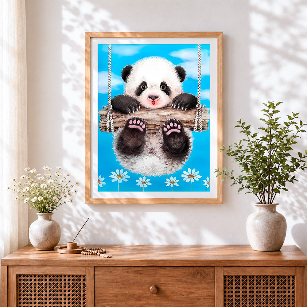 Finished panda on swing cross stitch artwork displayed