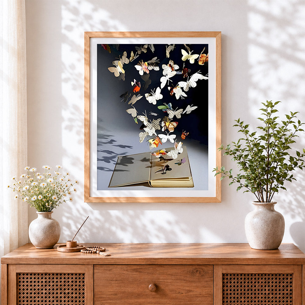 Finished paper butterflies flying from a book cross stitch artwork displayed