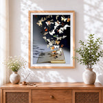 Finished paper butterflies flying from a book cross stitch artwork displayed