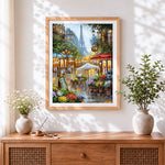 Finished parisian street cafe cross stitch artwork displayed