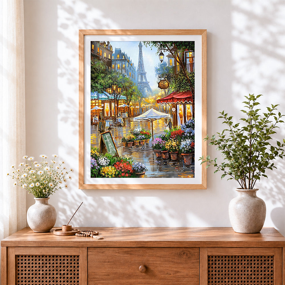 Finished parisian street cafe cross stitch artwork displayed