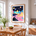 Pastel geometric mountains and planets cross stitch artwork displayed on wall as home decor