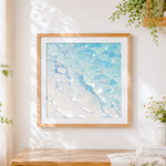 Finished pastel ocean waves cross stitch artwork displayed