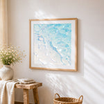 Pastel ocean waves cross stitch artwork displayed on wall as home decor