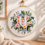 Pastel pink blooms and letter u embroidery hoop wall art displayed as warm and cosy handmade home decor
