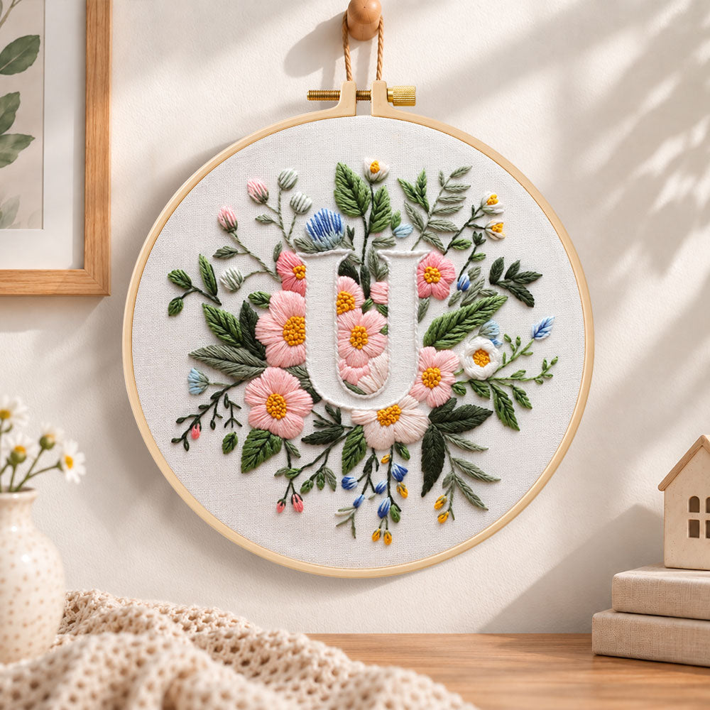 Pastel pink blooms and letter u embroidery hoop wall art displayed as warm and cosy handmade home decor