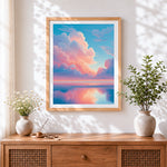 Finished pastel pink clouds and ocean reflection cross stitch artwork displayed