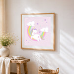 Pastel unicorn with rainbow and clouds cross stitch artwork displayed on wall as home decor