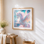 Pastel winged unicorn cross stitch artwork displayed on wall as home decor