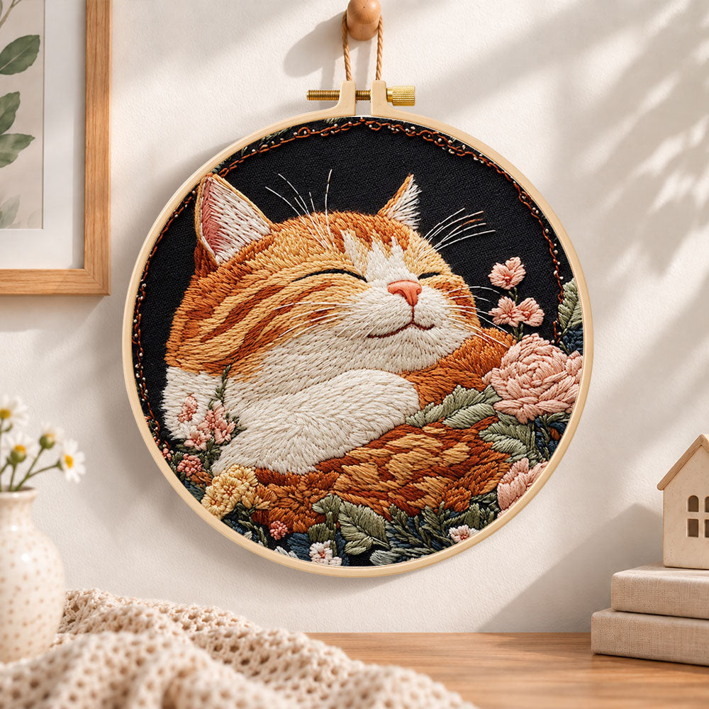 Peaceful sleeping tabby cat embroidery hoop wall art displayed as warm and cozy handmade home decor