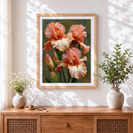 Finished peach and pink irises cross stitch artwork displayed