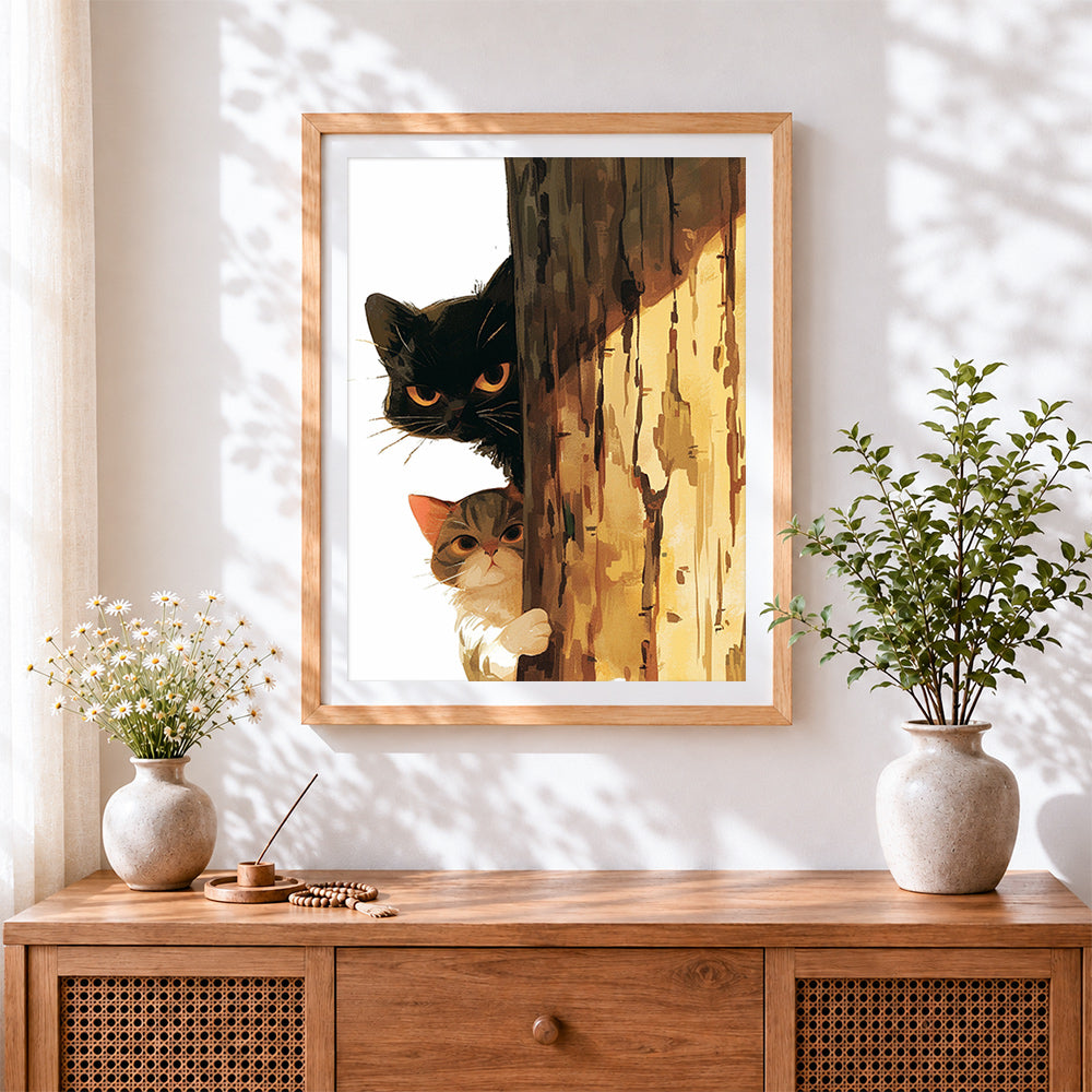 Finished peekaboo cats behind tree cross stitch artwork displayed