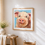 Pig portrait cross stitch artwork displayed on wall as home decor