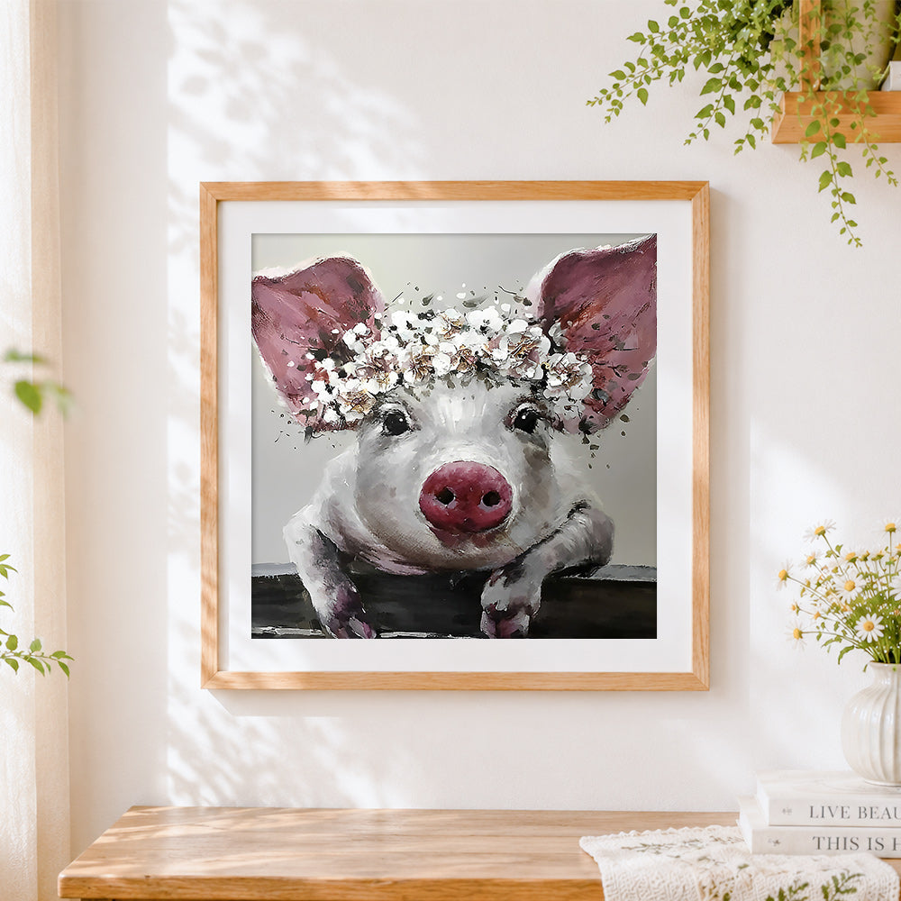 Finished pig with white floral crown cross stitch artwork displayed