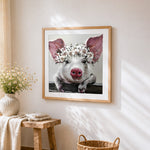 Pig with white floral crown cross stitch artwork displayed on wall as home decor
