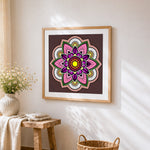 Pink and purple floral mandala cross stitch artwork displayed on wall as home decor