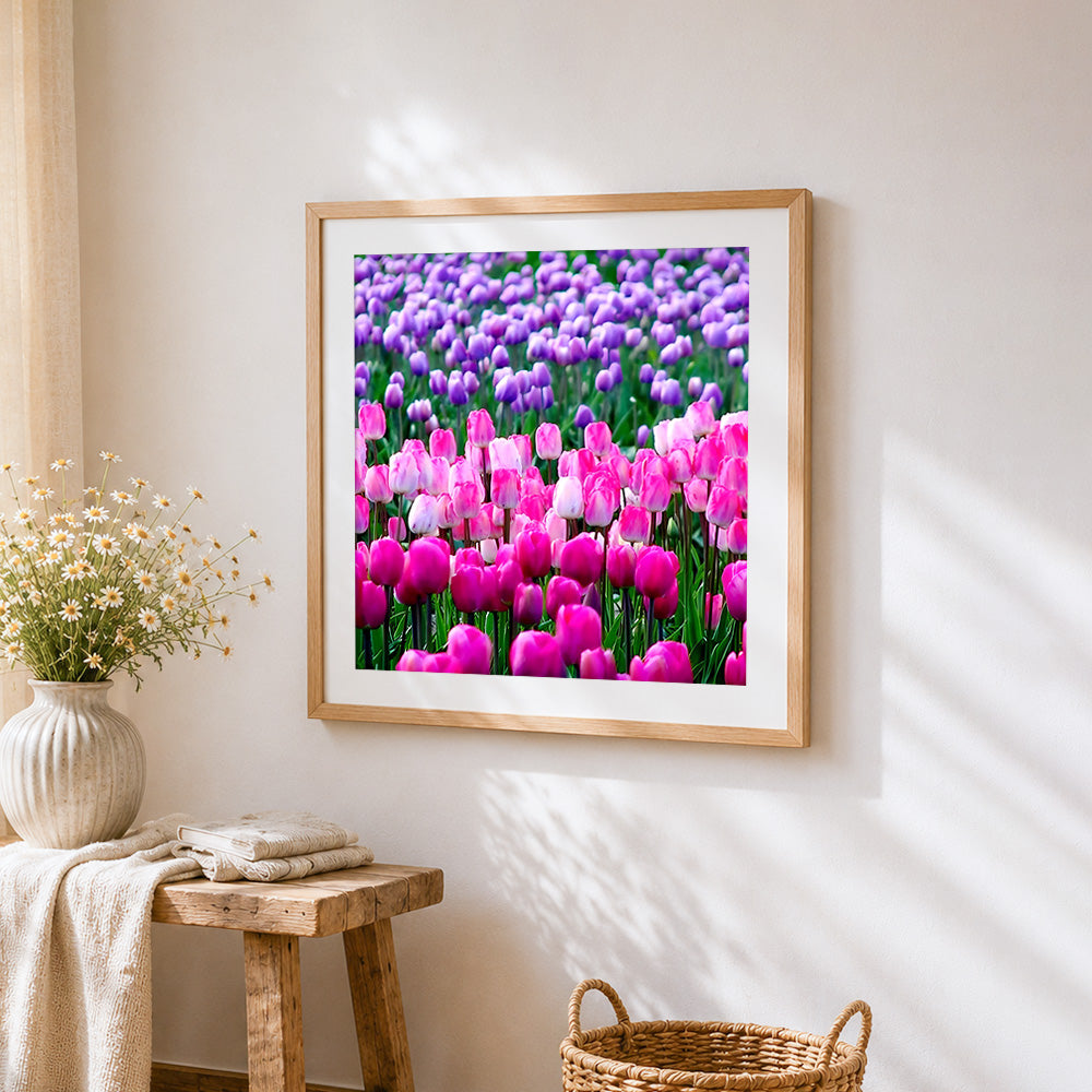 Pink and purple tulip field cross stitch artwork displayed on wall as home decor