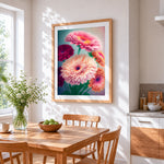 Pink and red gerbera daisies cross stitch artwork displayed on wall as home decor