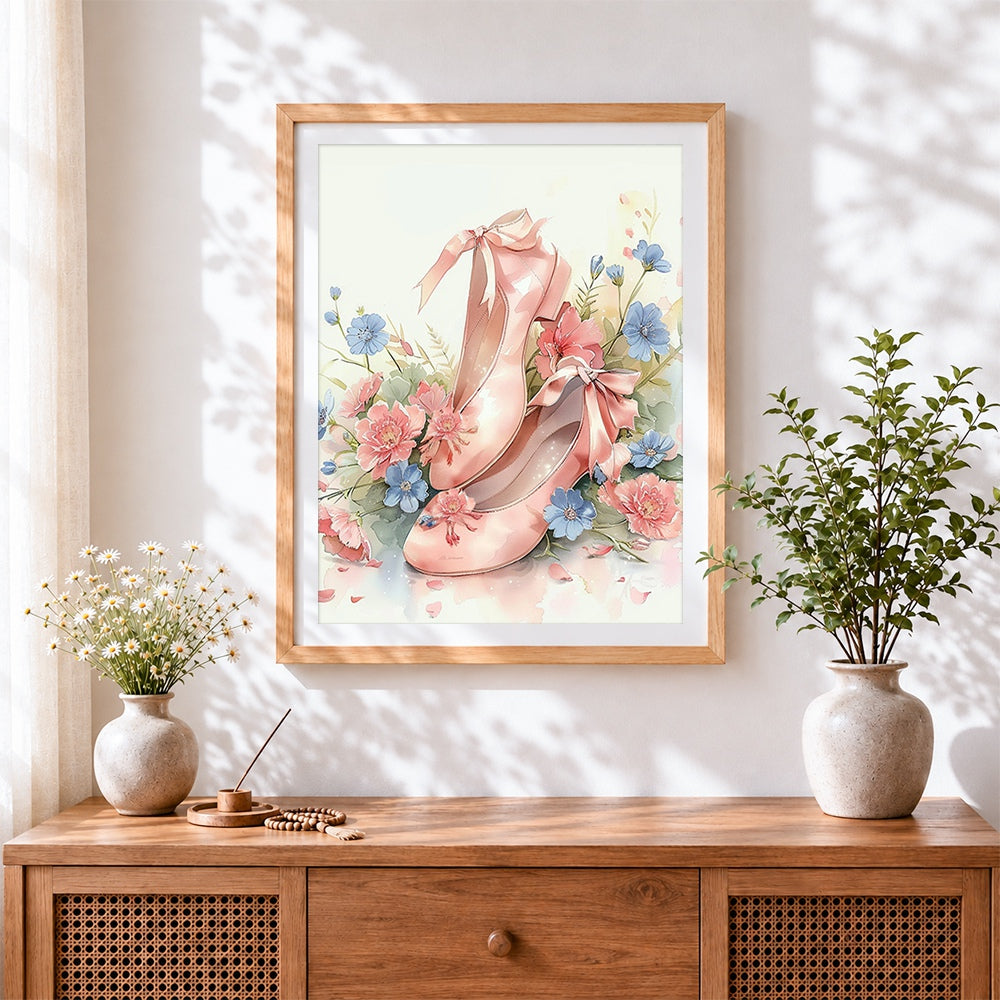 Finished pink ballet shoes and flowers cross stitch artwork displayed
