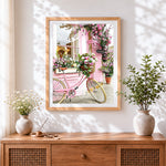 Finished pink bicycle with flower basket cross stitch artwork displayed