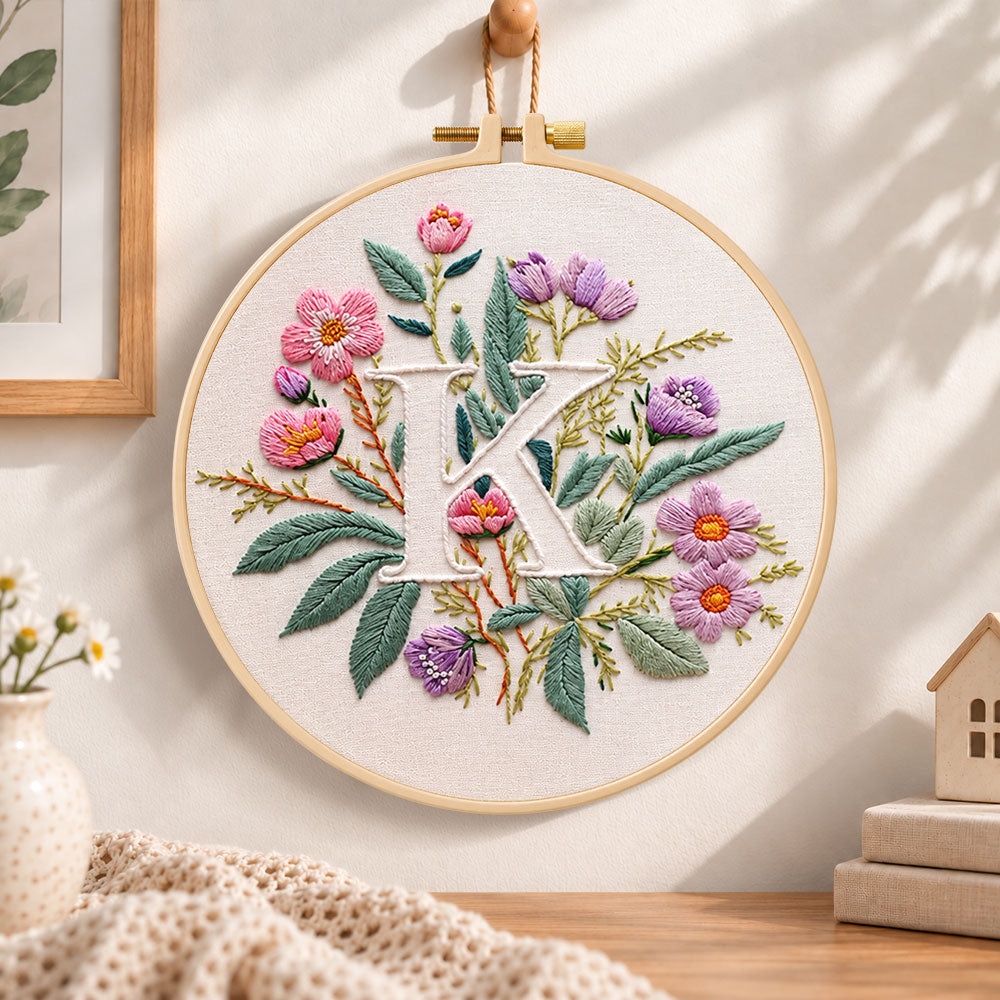 Pink blooms and letter k embroidery hoop wall art displayed as warm and cosy handmade home decor