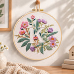Pink blooms and letter k embroidery hoop wall art displayed as warm and cosy handmade home decor