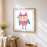 Pink boho owl cross stitch artwork displayed on wall as home decor