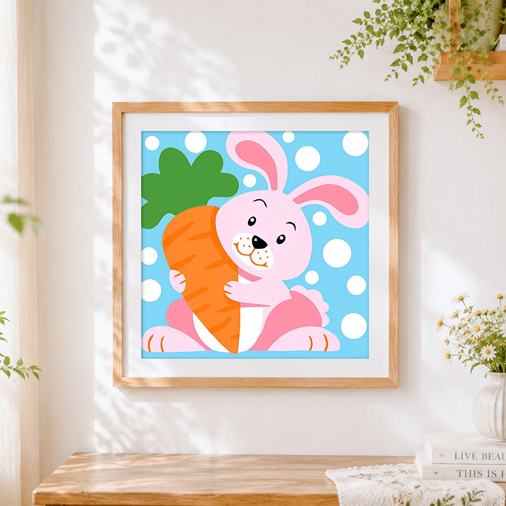 Finished pink bunny hugging carrot cross stitch artwork displayed