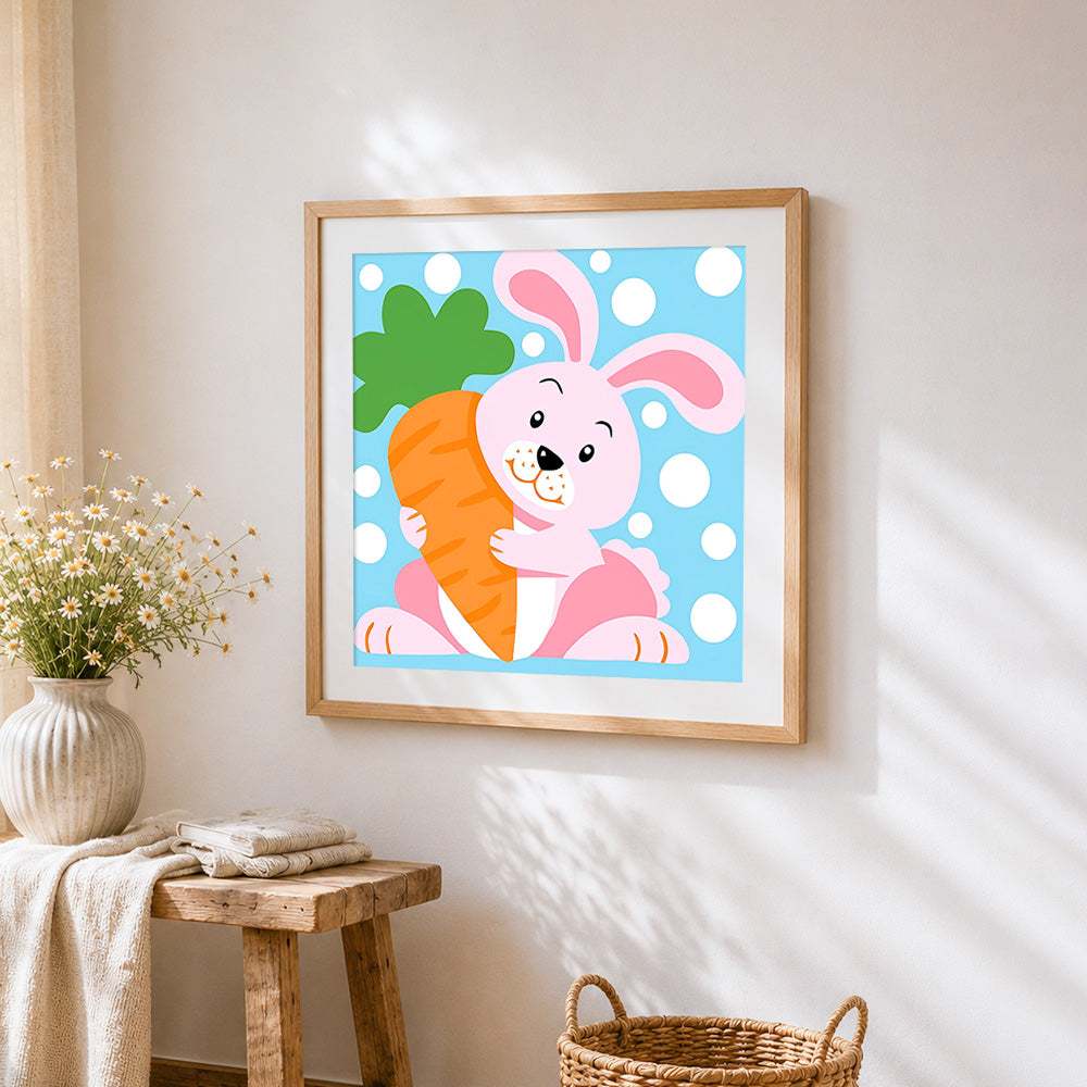 Pink bunny hugging carrot cross stitch artwork displayed on wall as home decor