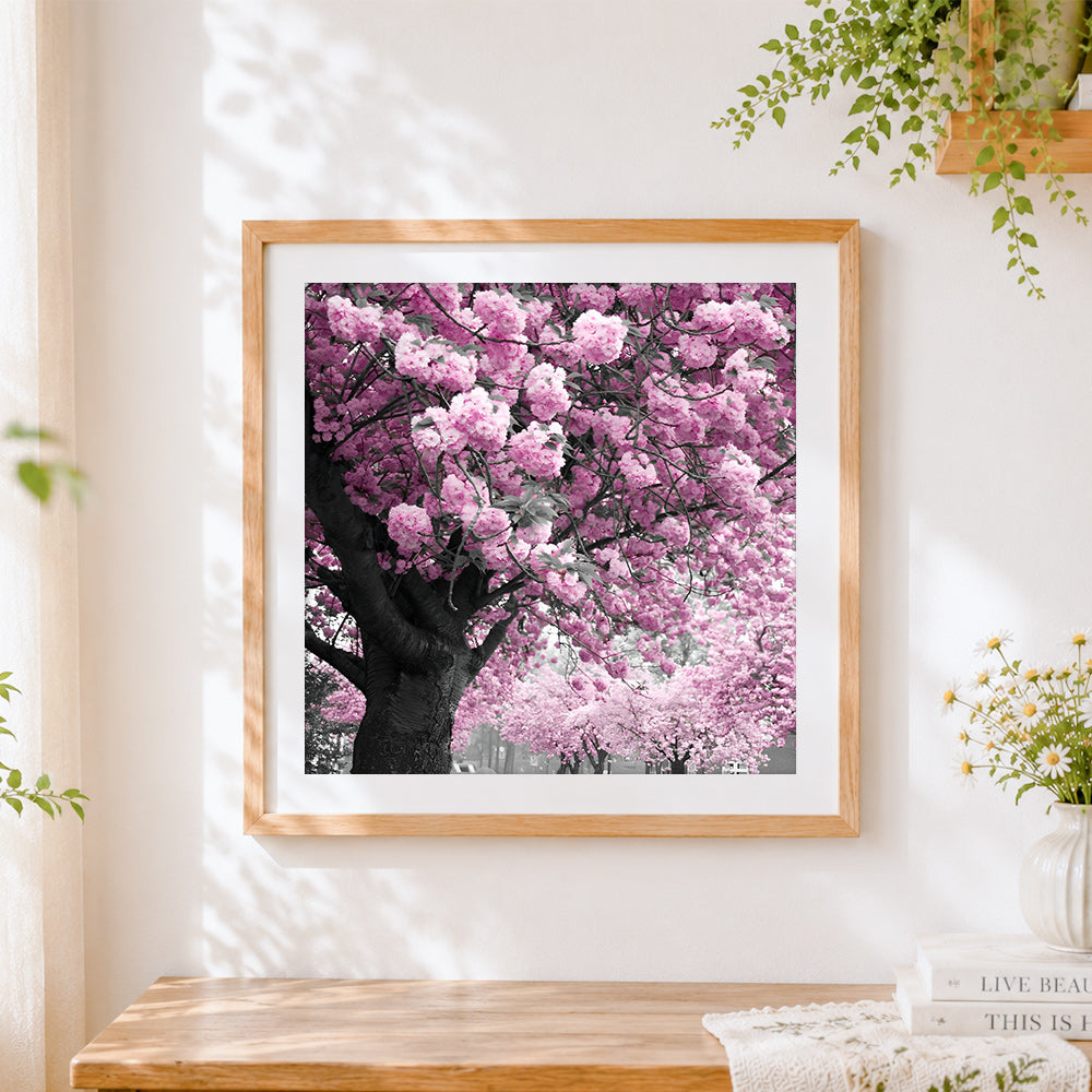 Finished pink cherry blossom tree cross stitch artwork displayed
