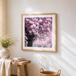 Pink cherry blossom tree cross stitch artwork displayed on wall as home decor