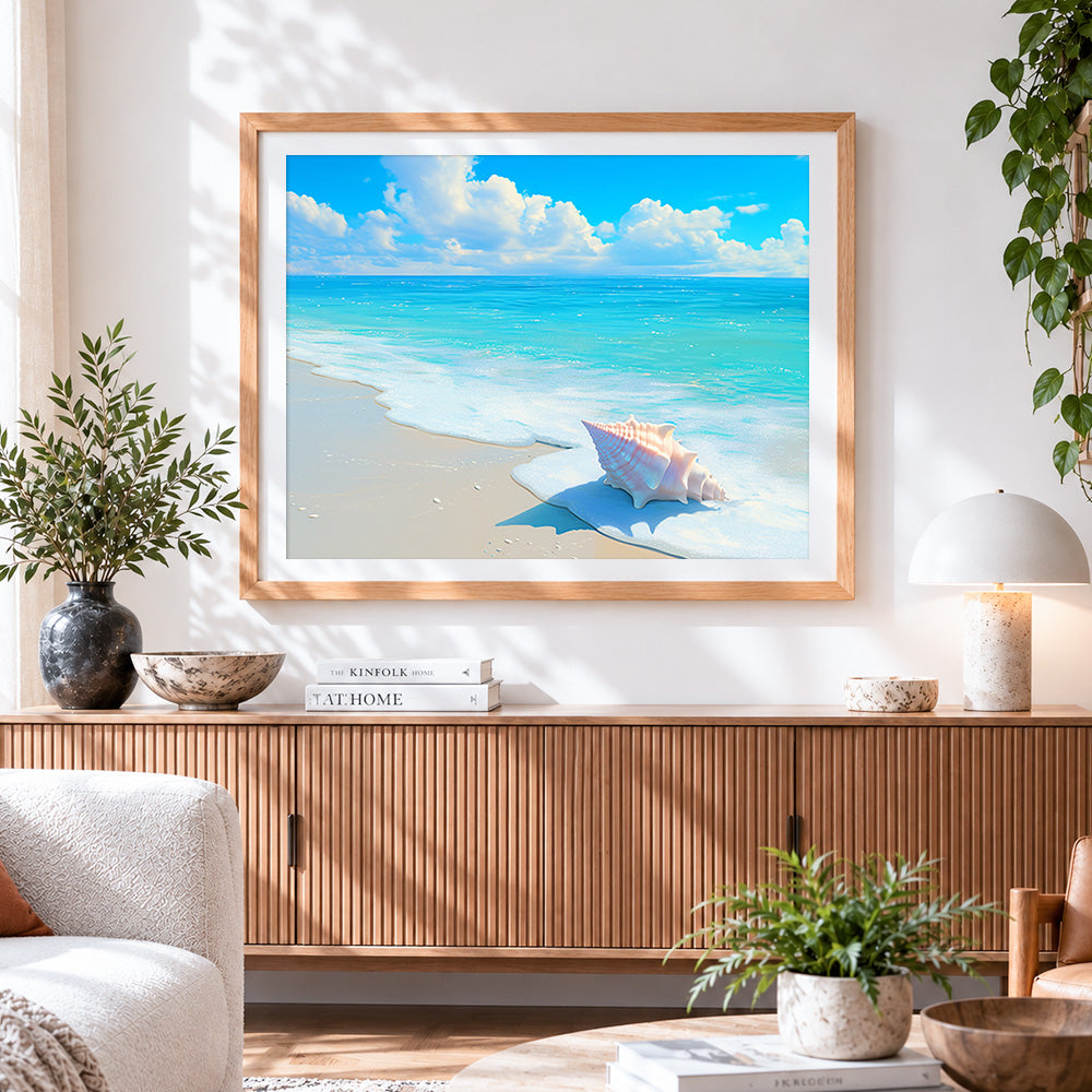 Finished pink conch shell on beach cross stitch artwork displayed