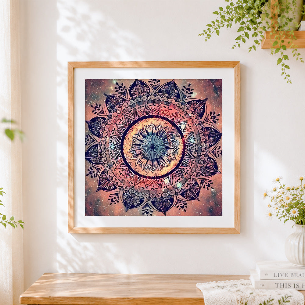 Finished pink cosmic mandala on starry background cross stitch artwork displayed