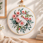 Pink daisy blooms and letter s embroidery hoop wall art displayed as warm and cosy handmade home decor