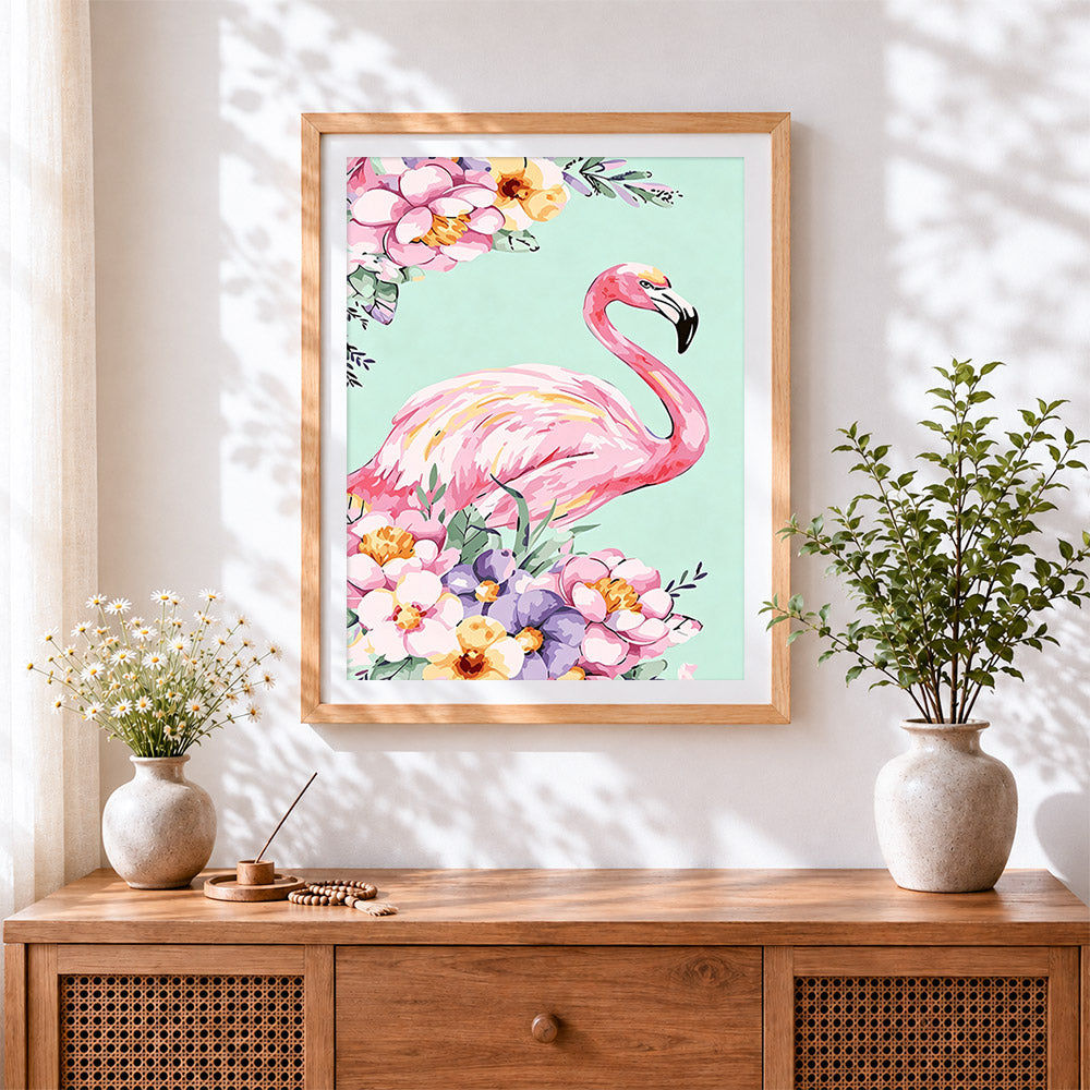 Finished pink flamingo and floral bouquet cross stitch artwork displayed