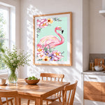 Pink flamingo and floral bouquet cross stitch artwork displayed on wall as home decor