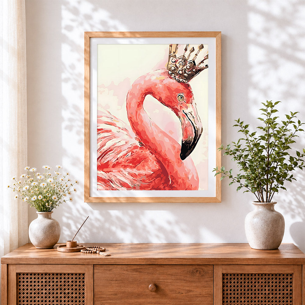 Finished pink flamingo with a crown cross stitch artwork displayed