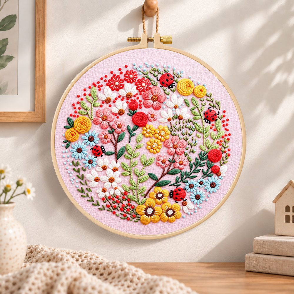 Pink floral art with ladybugs embroidery hoop wall art displayed as warm and cosy handmade home decor
