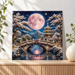 Finished pink full moon over snowy pagoda pearl diamond painting artwork displayed as holiday home decor