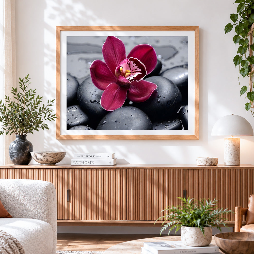 Finished pink orchid on black pebbles paint by numbers artwork displayed as home decor