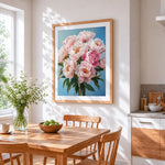 Pink peonies on a blue background cross stitch artwork displayed on wall as home decor