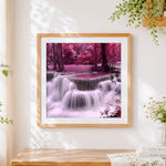 Finished pink purple forest waterfall cross stitch artwork displayed