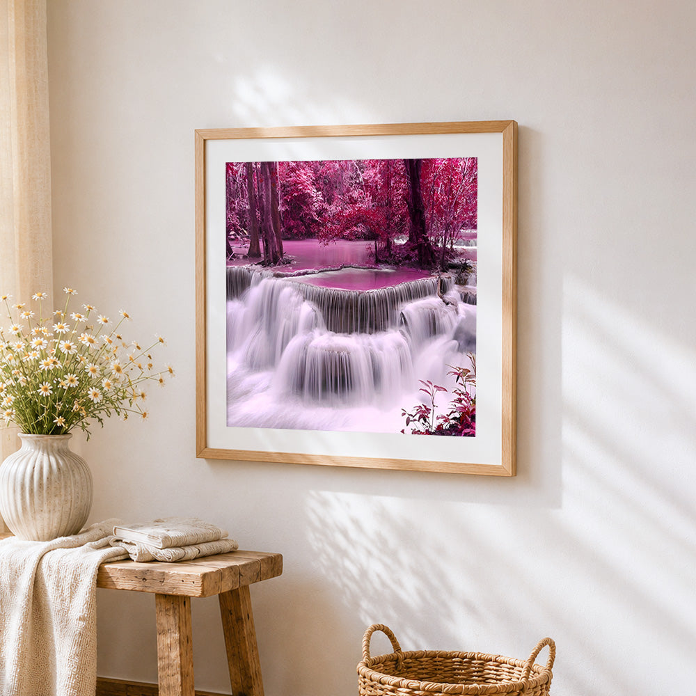 Pink purple forest waterfall cross stitch artwork displayed on wall as home decor