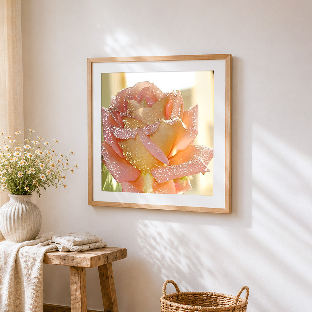 Pink rose with morning dew cross stitch artwork displayed on wall as home decor
